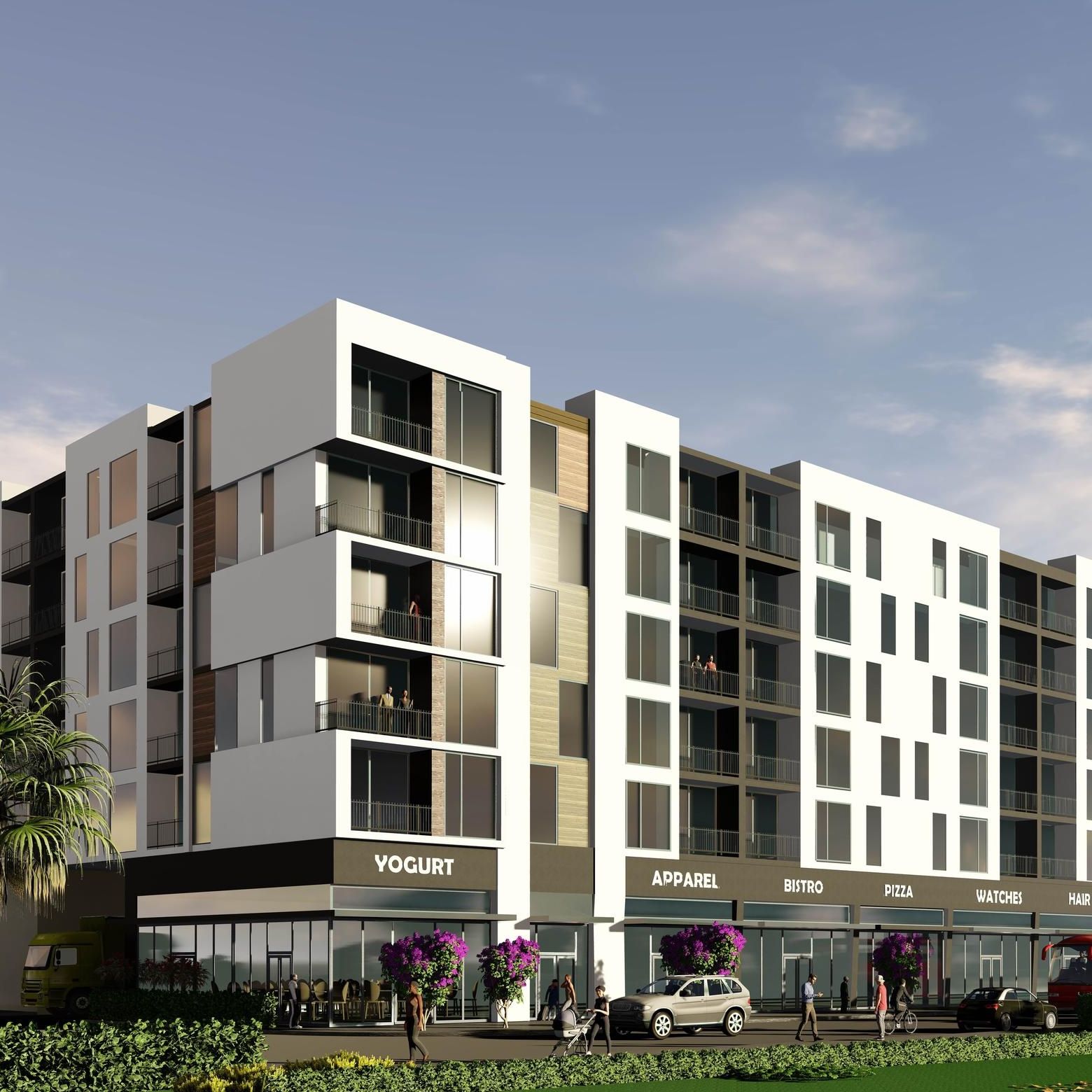 Northside Vistas apartments modern four-story building with various shops on the ground level and balconies above, against a clear sky.